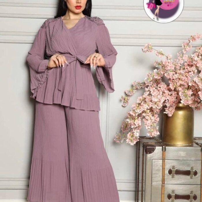 Model wearing lilac mauve Turkish pleated two-piece set with flowy sleeves, belted tunic, and wide-leg pants.