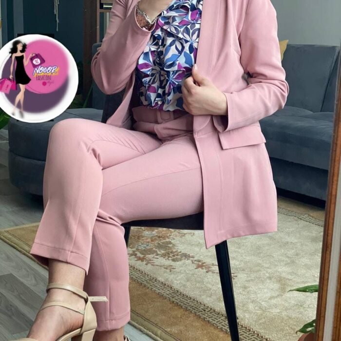 Model wearing blush pink Turkish tailored suit set with blazer and slim trousers – seated view.